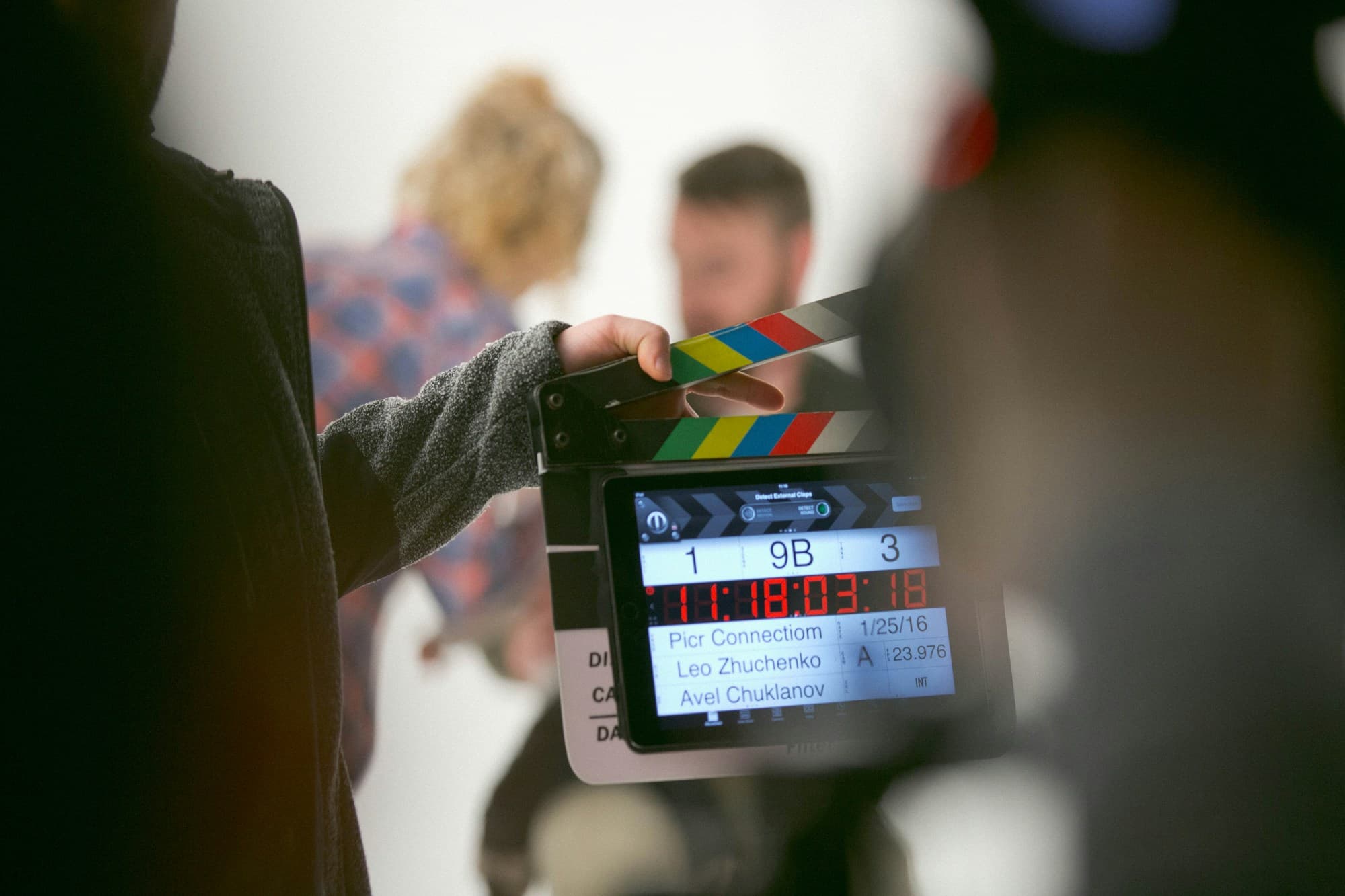 A clapperboard held in front of a camera on set